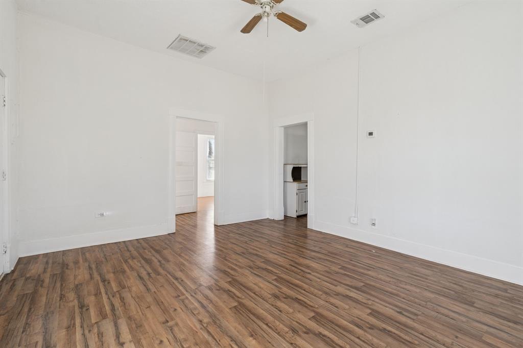 319 McKinney Street Mesquite, TX 75149 - Photo 7 of 27 a view of an empty room with wooden floor