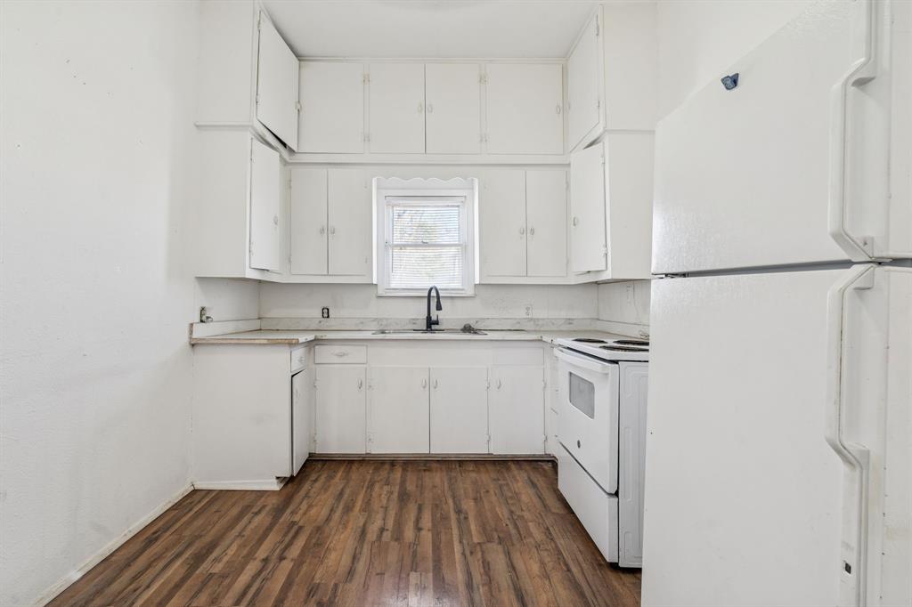 319 McKinney Street Mesquite, TX 75149 - Photo 9 of 27 a kitchen with a sink window and white cabinets