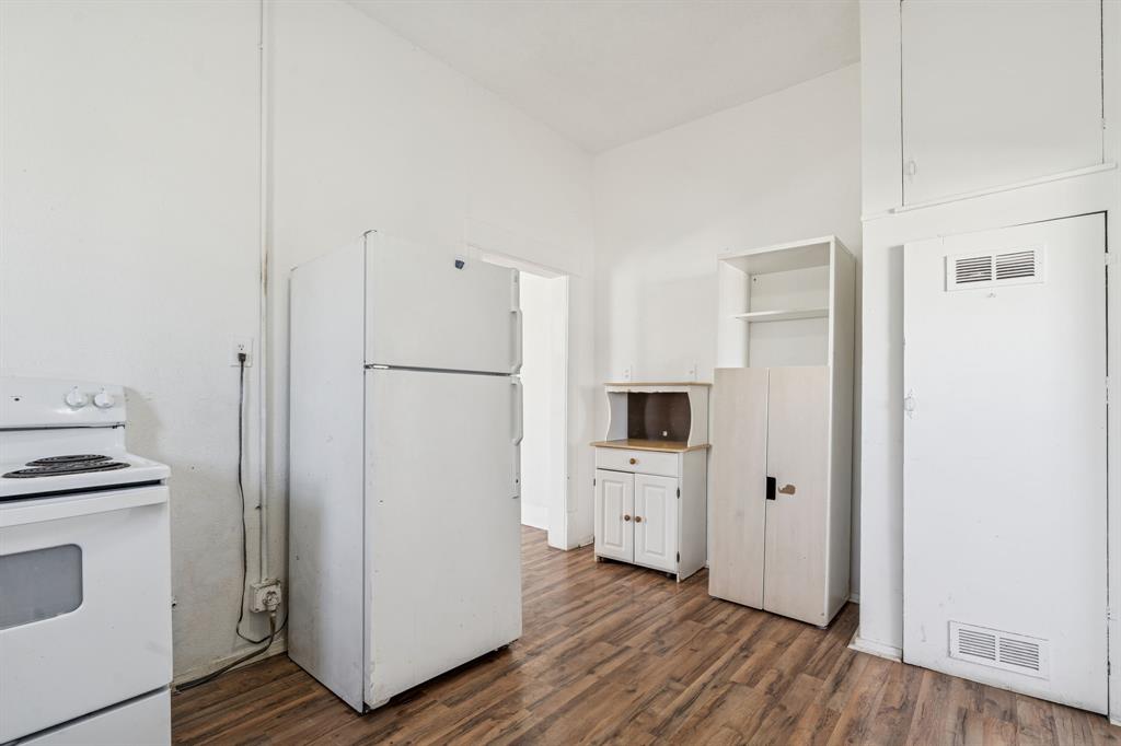 319 McKinney Street Mesquite, TX 75149 - Photo 10 of 27 a kitchen with cabinets and a refrigerator