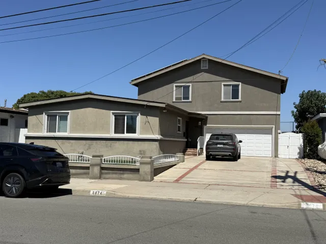 a view of a car parked in front of a house