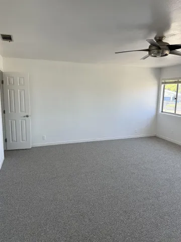 a view of an empty room and a window