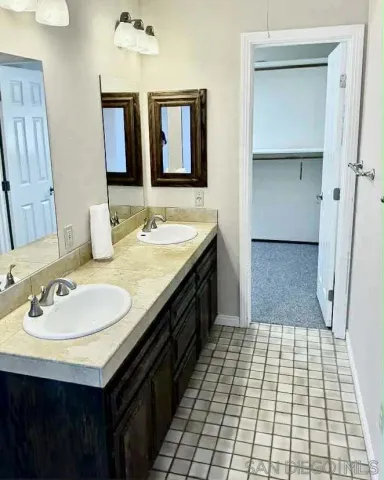 a bathroom with a sink a double vanity and a mirror