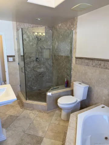 a bathroom with a sink mirror and shower
