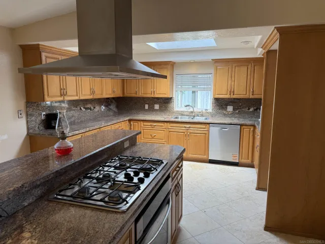 a kitchen with wooden cabinets and a stove top oven