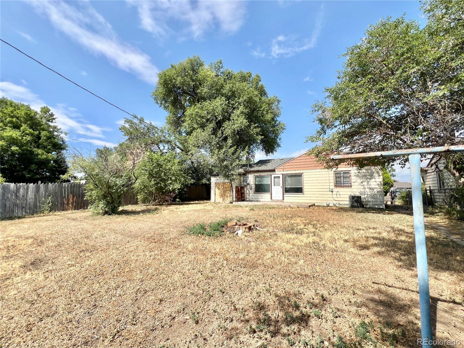 3580 Oneida Street Denver, CO 80207 - Photo 13 of 13 a house with a tree in front of it