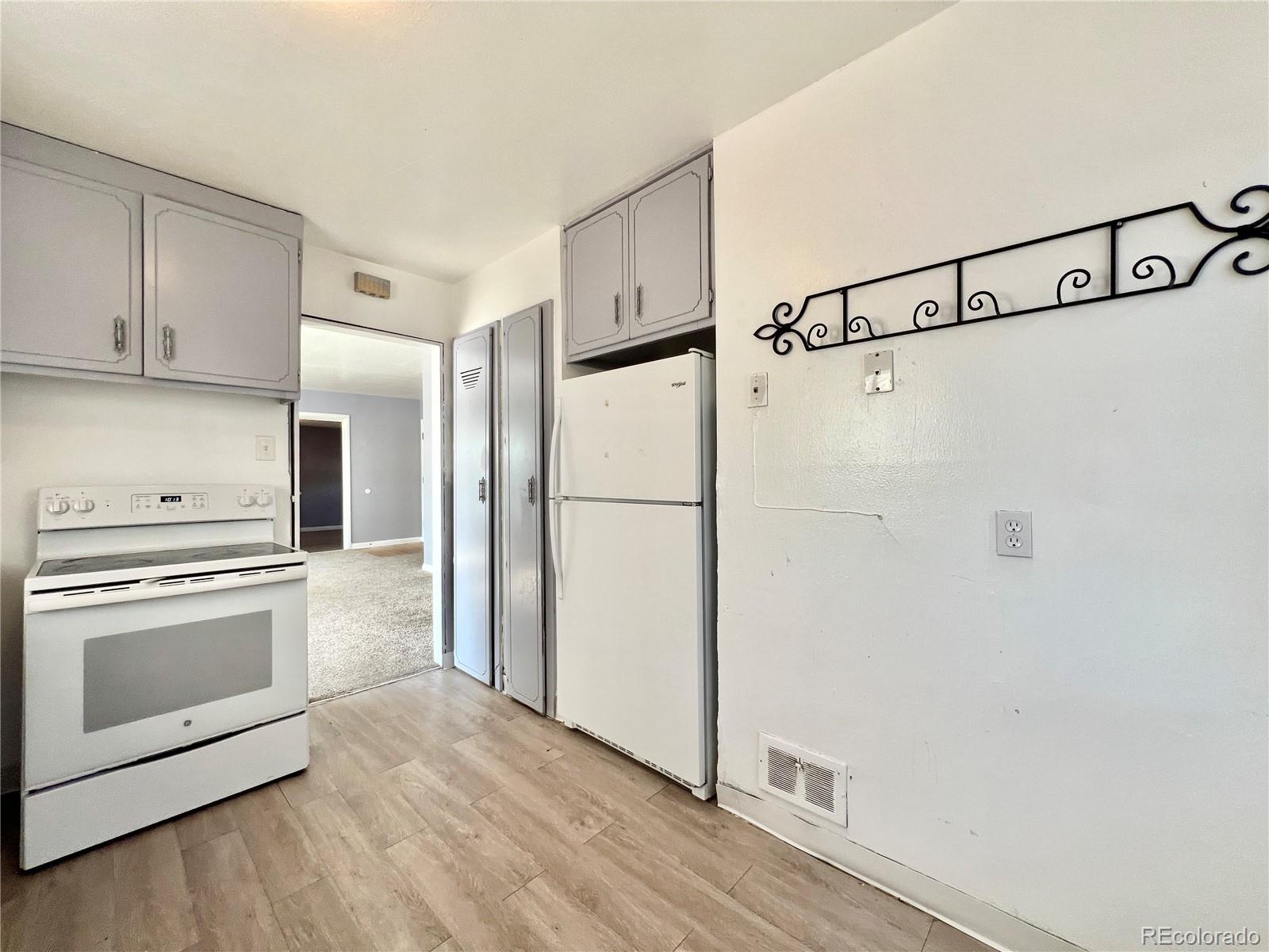 3580 Oneida Street Denver, CO 80207 - Photo 4 of 13 a kitchen with cabinets and stainless steel appliances