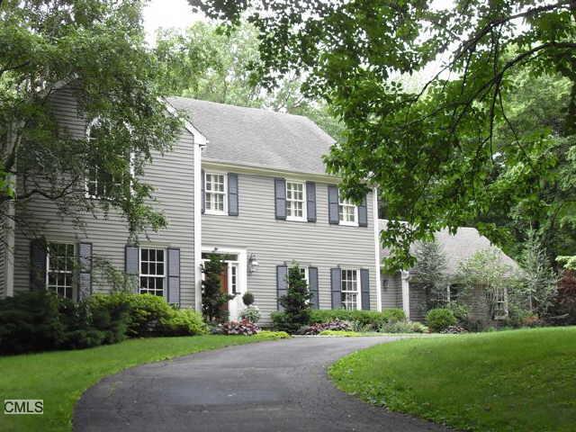 a front view of a house with a garden and plants