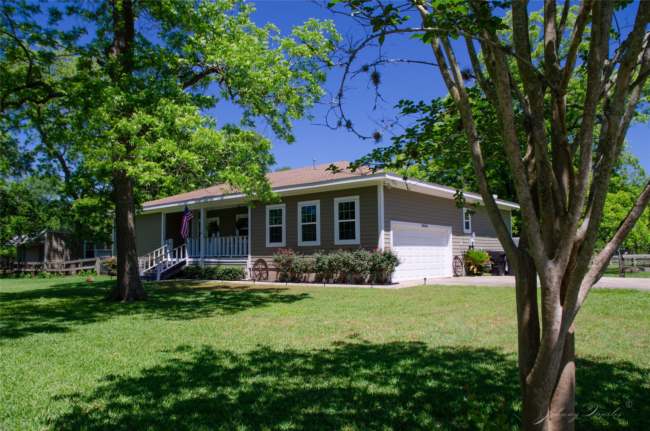 a front view of a house with a yard and trees