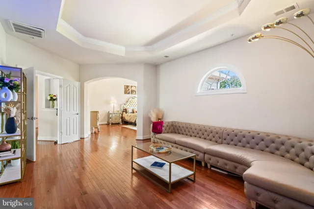 a living room with furniture and wooden floor