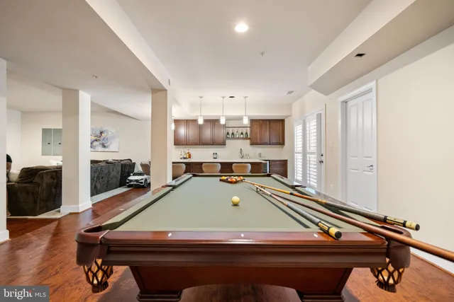 a room with wooden furniture and pool table