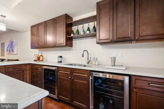 a kitchen with stainless steel appliances granite countertop a sink dishwasher stove and cabinets with wooden floor