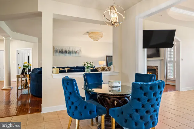 a view of a dining room with furniture wooden floor and chandelier