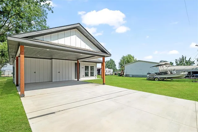 a front view of house with yard and trees