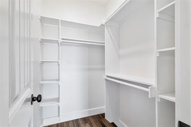 a view of walk in closet with empty racks