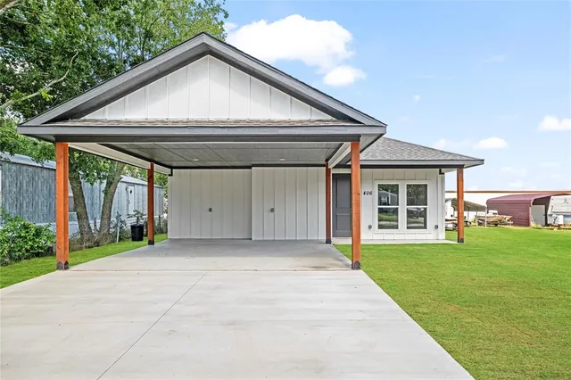 a view of a house with a yard and porch