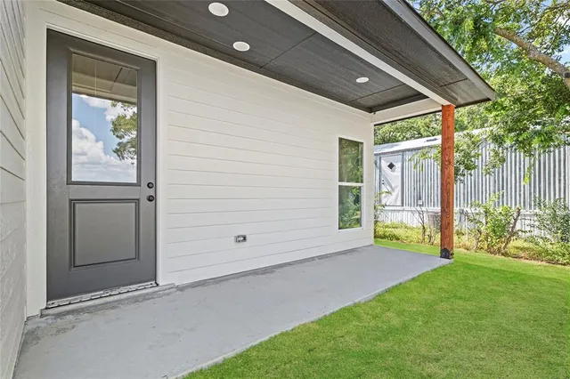 a view of an entrance to house with yard
