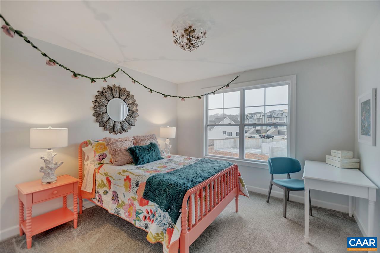 3490 Thicket Run Place Charlottesville, VA 22911 - Photo 15 of 36 a bedroom with a bed and a table in it