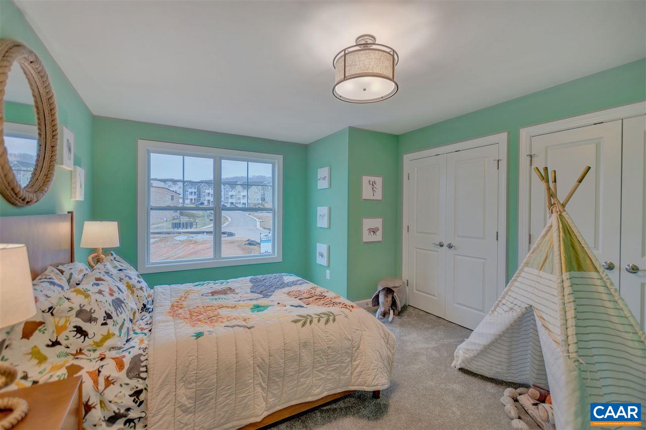 3490 Thicket Run Place Charlottesville, VA 22911 - Photo 17 of 36 a bedroom with a bed and a chandelier