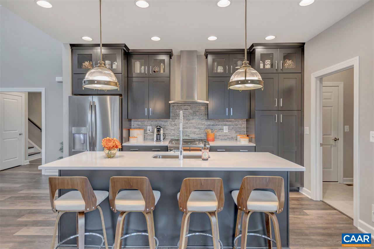 3490 Thicket Run Place Charlottesville, VA 22911 - Photo 10 of 36 a kitchen with stainless steel appliances kitchen island granite countertop a kitchen island and chairs in it