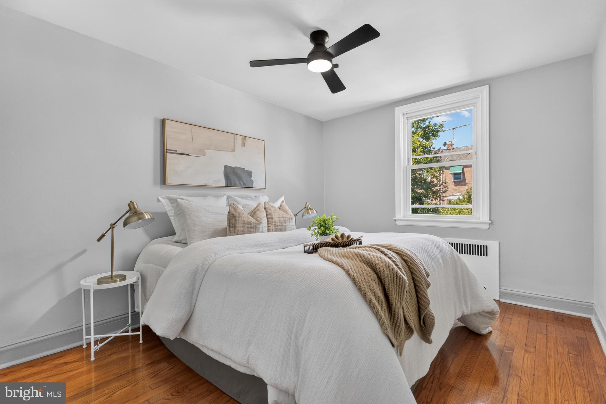 3906 Yolando Road Baltimore, MD 21218 - Photo 12 of 30 a bedroom with a bed and wooden floor