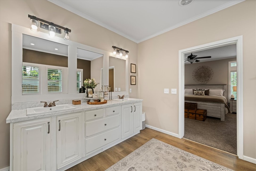 116 Parkview Road Iva, SC 29655 - Photo 26 of 44 Dual vanity with bright lighting offers practical luxury, connecting seamlessly to a plush primary bedroom.