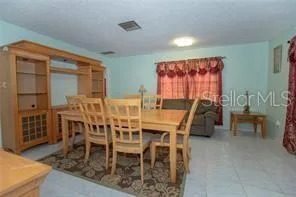 a view of a dining room with furniture and chandelier