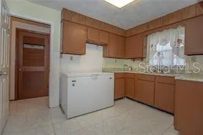 a kitchen with a sink cabinets and wooden floor