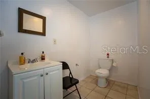 a bathroom with a sink toilet and a mirror