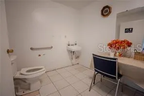 a bathroom with a toilet a sink and a mirror