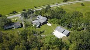 an aerial view of a house with a yard