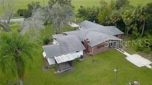 an aerial view of a house with a yard