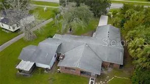 an aerial view of a house with swimming pool and garden