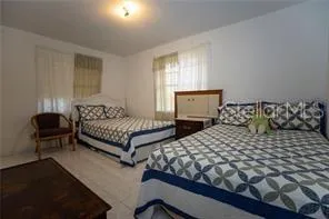 a bedroom with double bed and a window