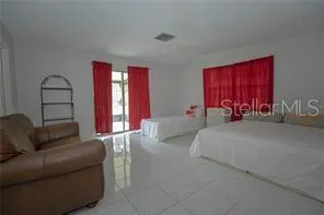 a bed room with couch and window