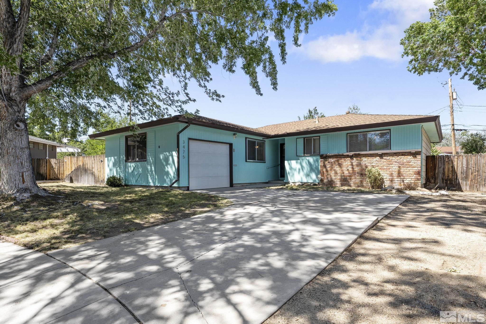 a view of a house with a yard and garage