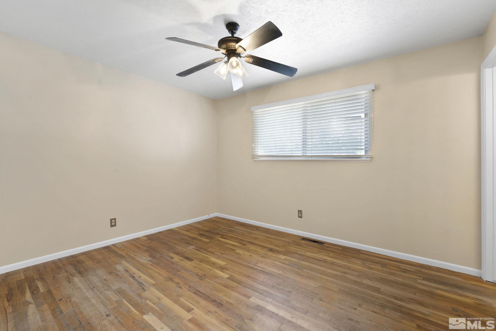3475 Greta Place Reno, NV 89503 - Photo 16 of 36 wooden floor in an empty room with a window