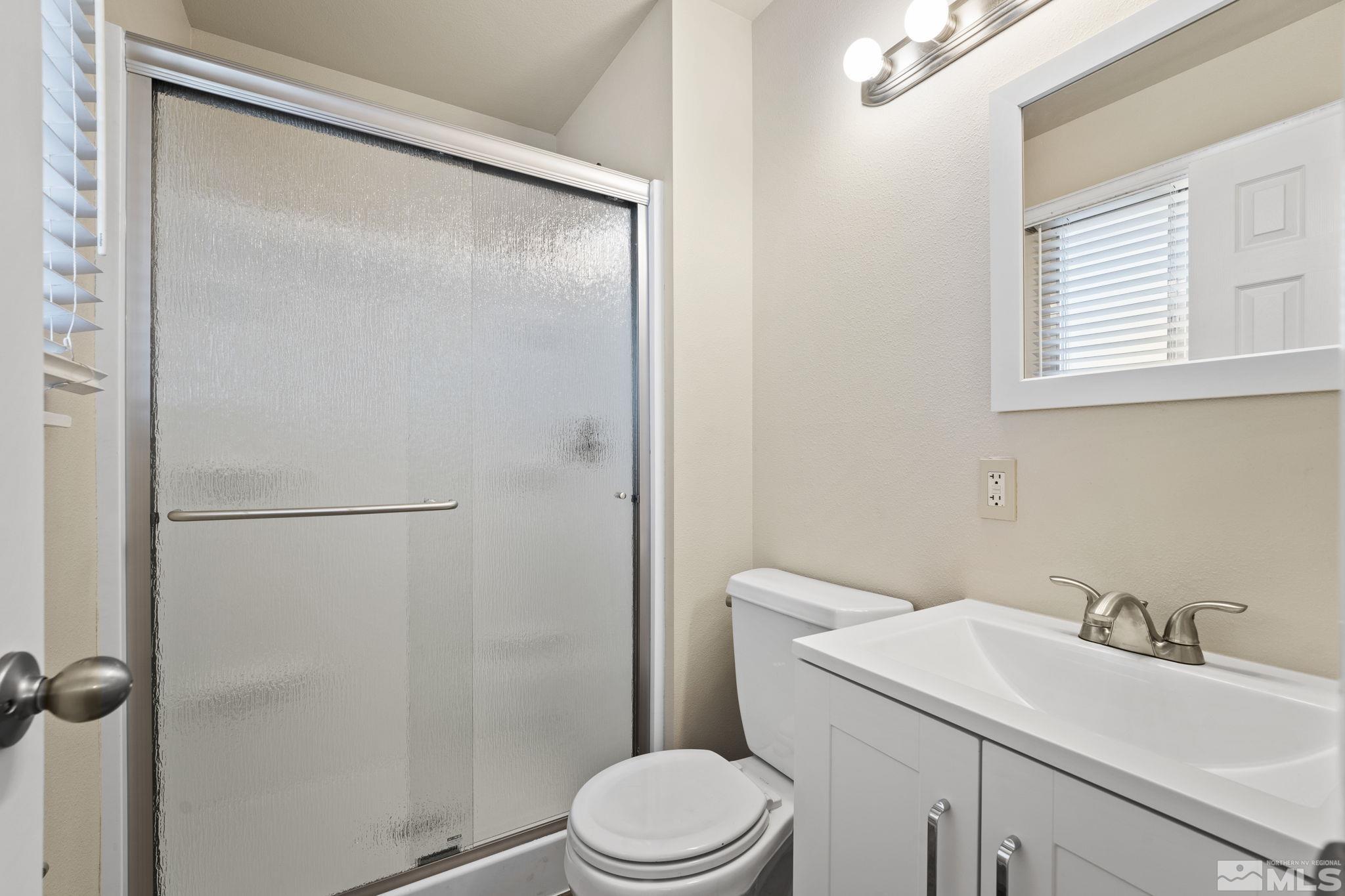 3475 Greta Place Reno, NV 89503 - Photo 19 of 36 a bathroom with a sink toilet and a mirror