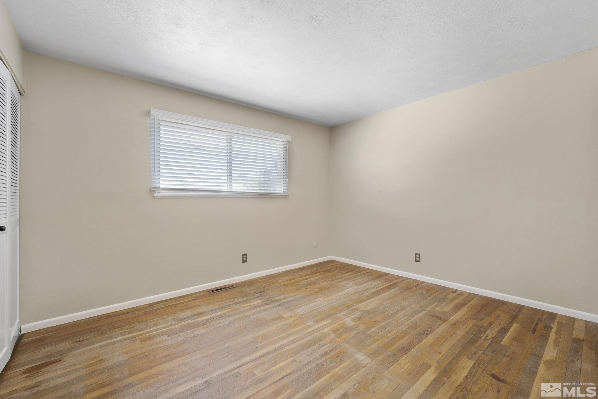 3475 Greta Place Reno, NV 89503 - Photo 20 of 36 an empty room with wooden floor and windows