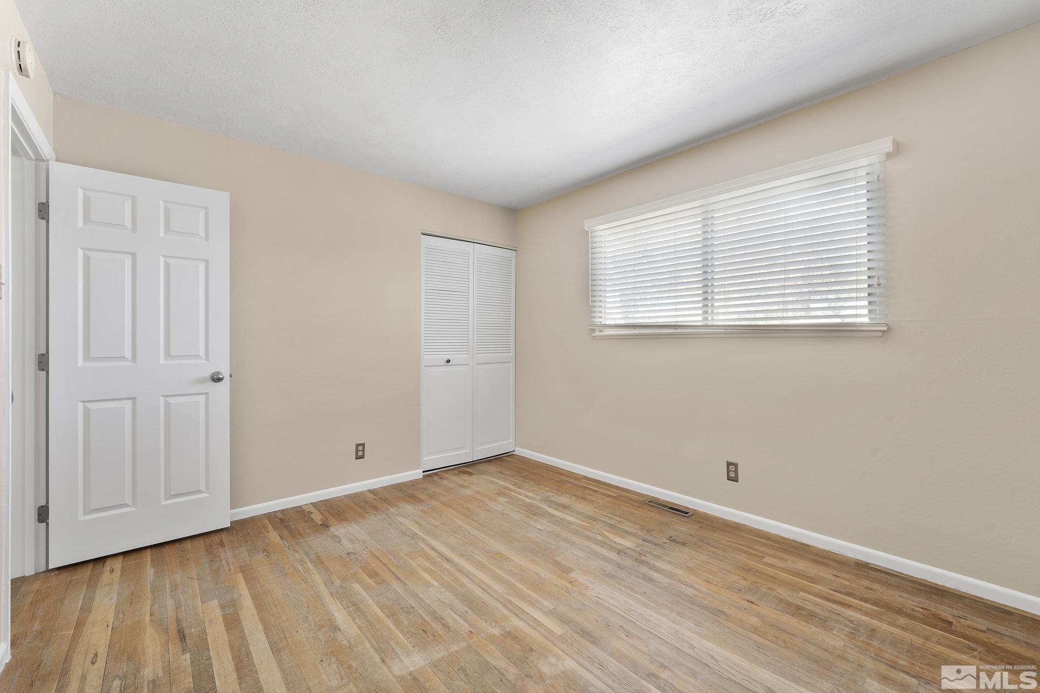 3475 Greta Place Reno, NV 89503 - Photo 21 of 36 an empty room with wooden floor and windows