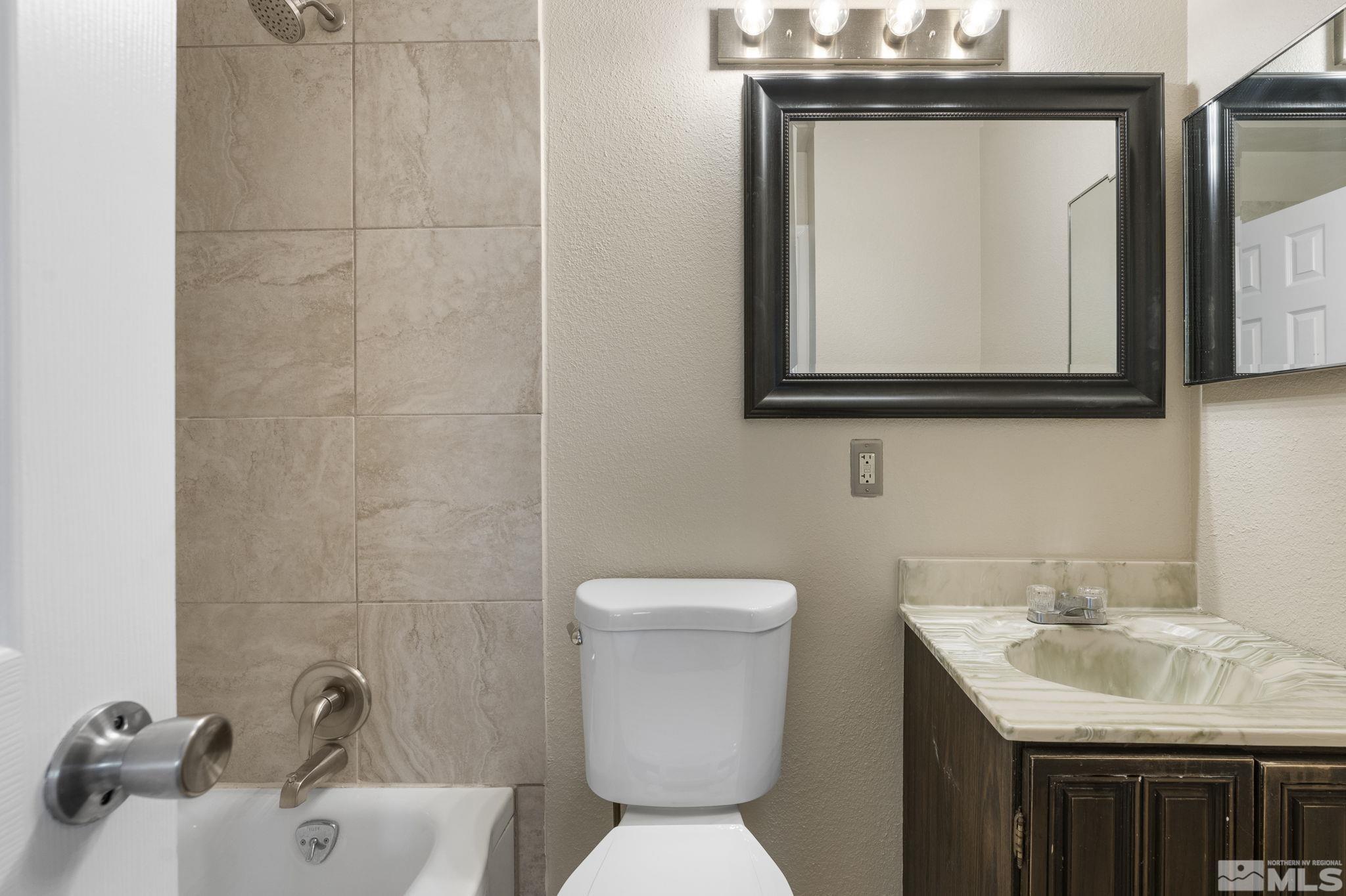 3475 Greta Place Reno, NV 89503 - Photo 24 of 36 a bathroom with a toilet sink and mirror
