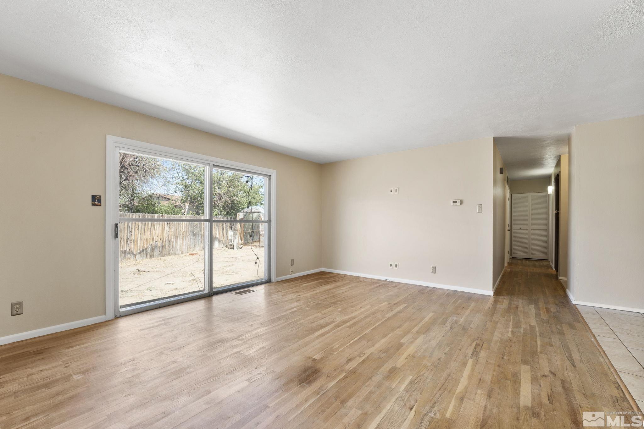 3475 Greta Place Reno, NV 89503 - Photo 4 of 36 a view of an empty room with wooden floor and a window