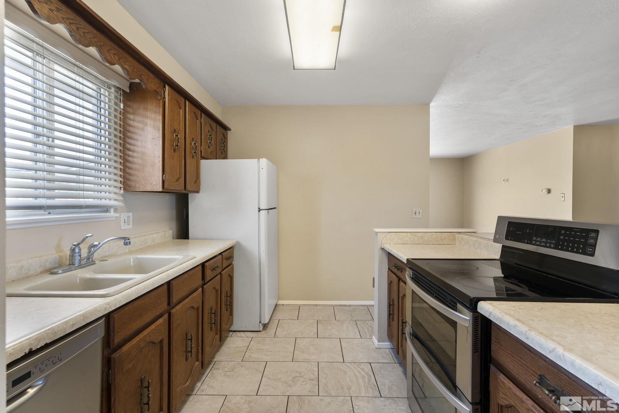 3475 Greta Place Reno, NV 89503 - Photo 9 of 36 a kitchen with a sink stove and refrigerator