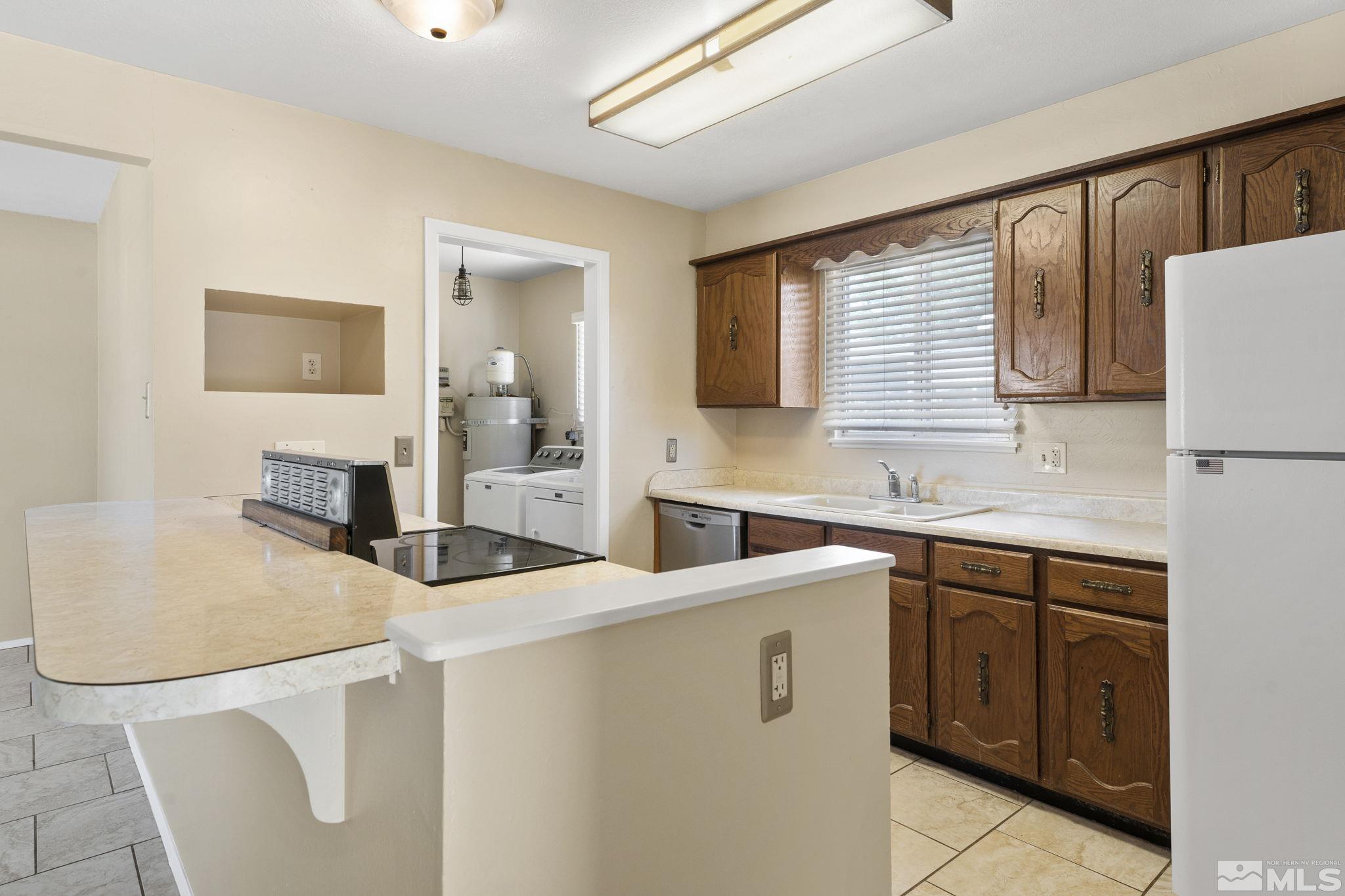 3475 Greta Place Reno, NV 89503 - Photo 10 of 36 a kitchen with a sink a stove and cabinets