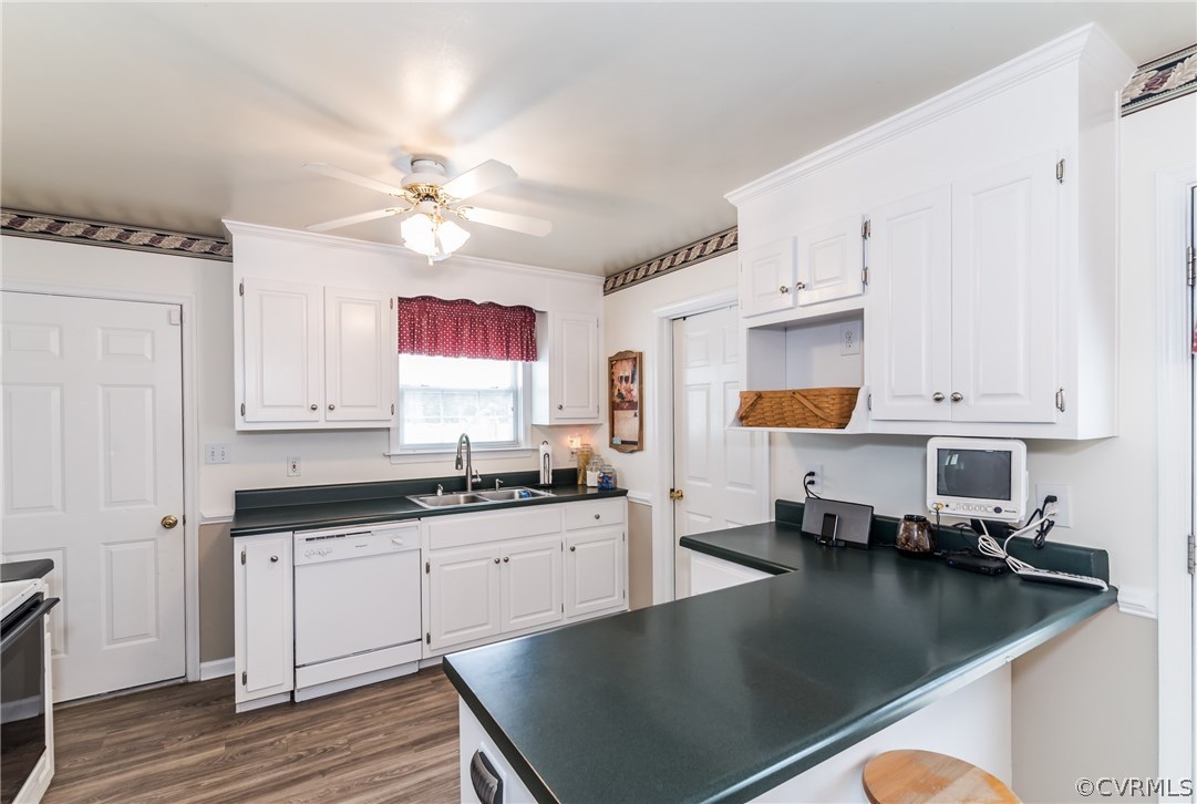 17445 Loving Union Road Disputanta, VA 23842 - Photo 18 of 50 a kitchen with stainless steel appliances granite countertop a sink dishwasher and cabinets with wooden floor