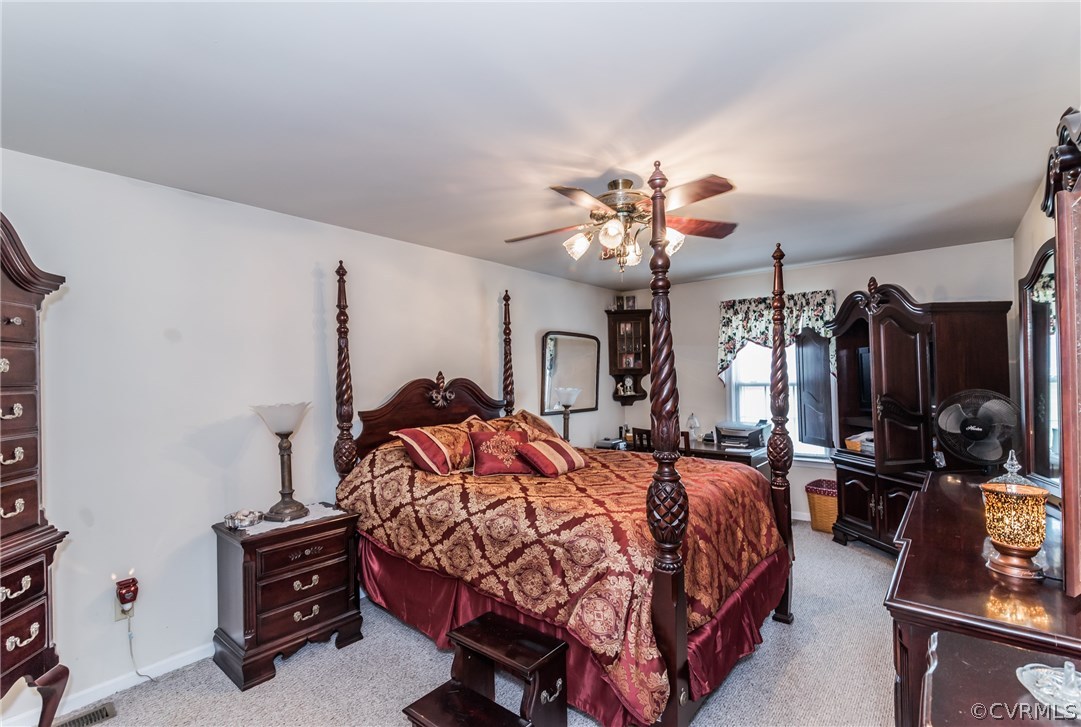 17445 Loving Union Road Disputanta, VA 23842 - Photo 2 of 50 a bedroom with a bed and a chandelier