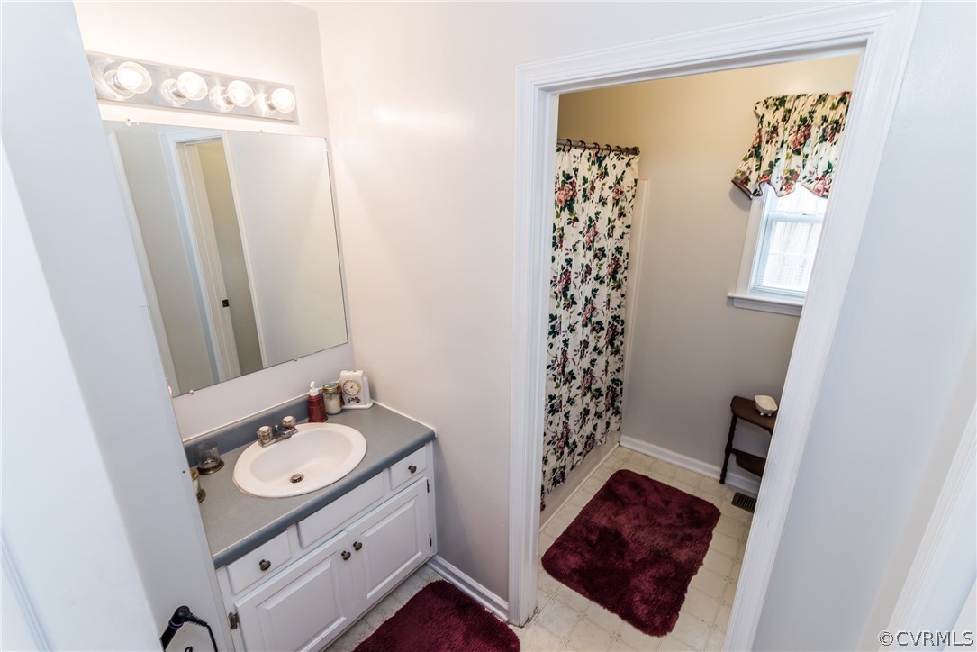 17445 Loving Union Road Disputanta, VA 23842 - Photo 22 of 50 a bathroom with a sink a mirror and a shower