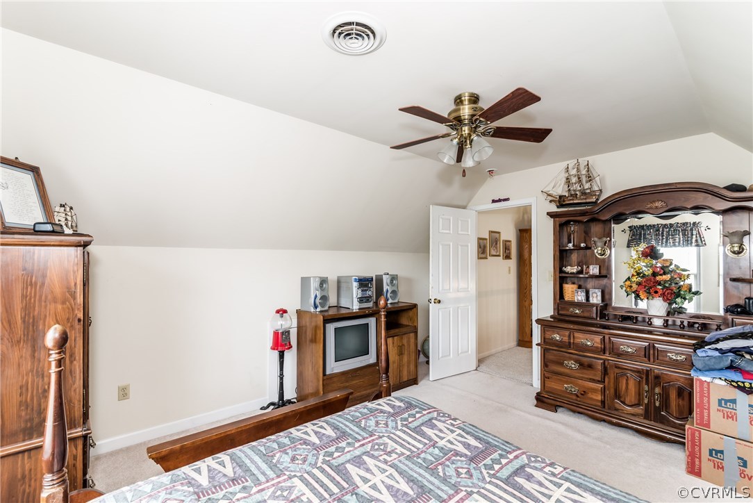 17445 Loving Union Road Disputanta, VA 23842 - Photo 25 of 50 a bedroom with furniture and a chandelier