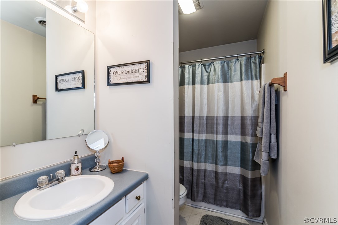 17445 Loving Union Road Disputanta, VA 23842 - Photo 27 of 50 a bathroom with a sink vanity granite and a mirror