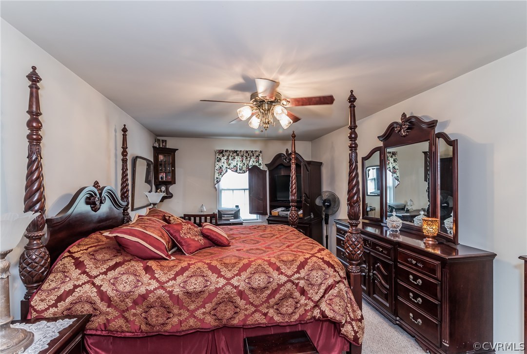 17445 Loving Union Road Disputanta, VA 23842 - Photo 3 of 50 a bed room with a bed and a chandelier