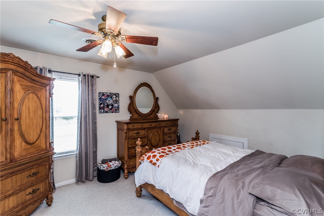 17445 Loving Union Road Disputanta, VA 23842 - Photo 32 of 50 a bedroom with a bed and a chandelier